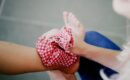 Icing an Ankle Injury with a cold pack in red fabric